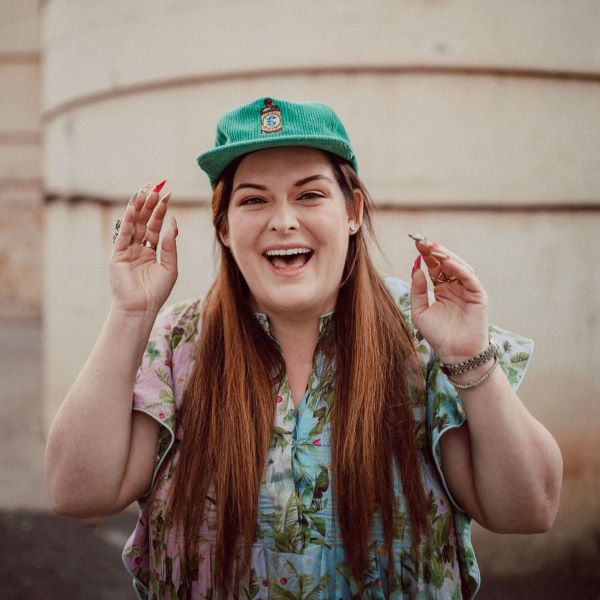 Christa Cotton wearing the El Guapo branded green corduroy baseball hat.