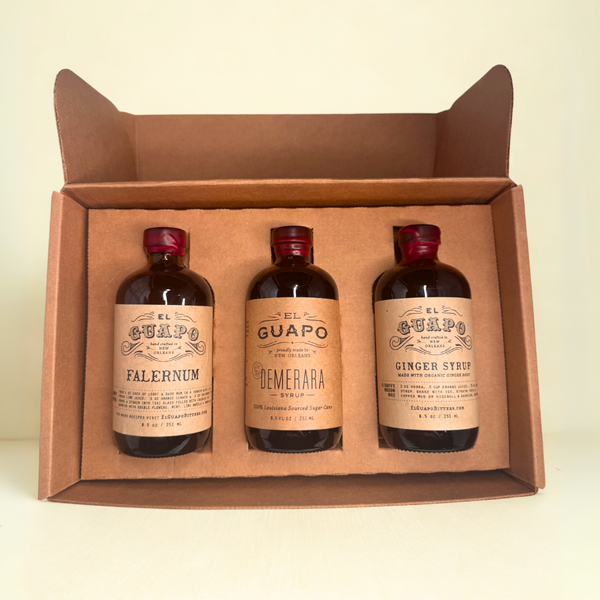 Three bottles of El Guapo Syrups in a brown craft shipping mailer
