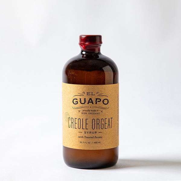 Large bottle of El Guapo Creole Orgeat Syrup on a white background