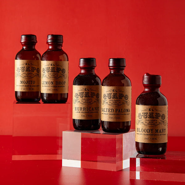 Five bottles of El Guapo Single Serving Mixers on a red background