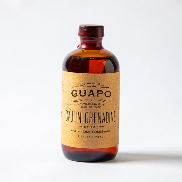 Bottle of 8.5 oz El Guapo Cajun Grenadine Syrup on a white background