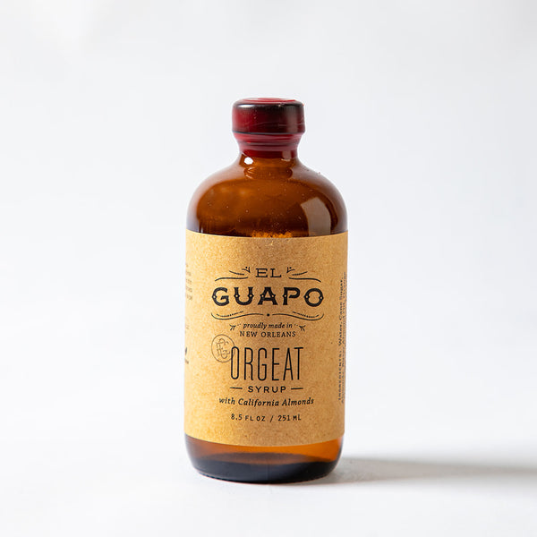 8.5 oz small glass bottle of El Guapo Orgeat Syrup on a white background