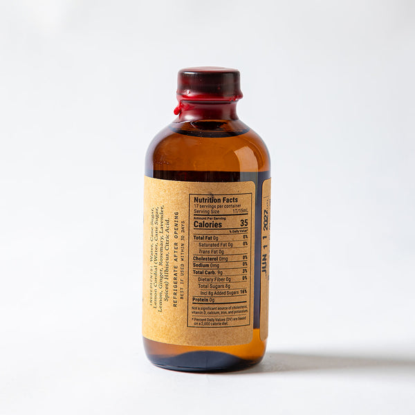 Side profile of El Guapo Hibiscus Syrup with Nutritional Panel and ingredient list showing on a white background
