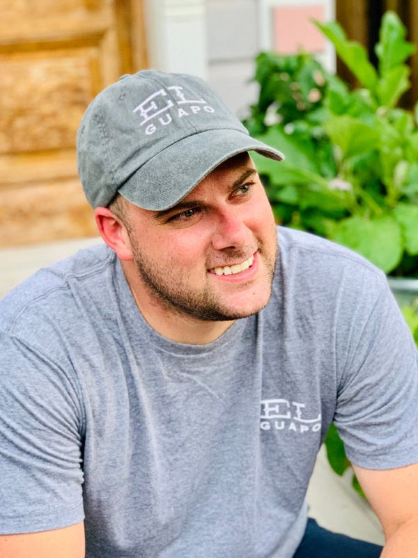 Model wearing El Guapo branded grey washed baseball cap and logo tee.