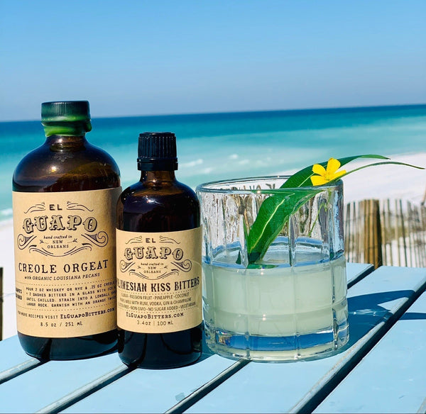 Clarified Jungle Bird Milk Punch cocktail with El Guapo Creole Orgeat and Bitters at the beach