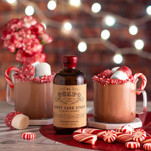 Peppermint hot chocolate mugs next to El Guapo Candy Cane Syrup