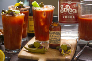 Loaded Carnival Bloody Mary cocktails next to El Guapo Crawfish Boil Bitters
