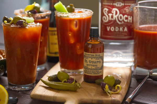 Loaded Carnival Bloody Mary cocktails next to El Guapo Crawfish Boil Bitters