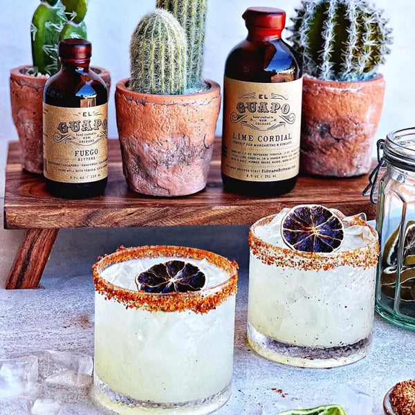 Tajin-rimmed margaritas with El Guapo cocktail mixers and potted cacti
