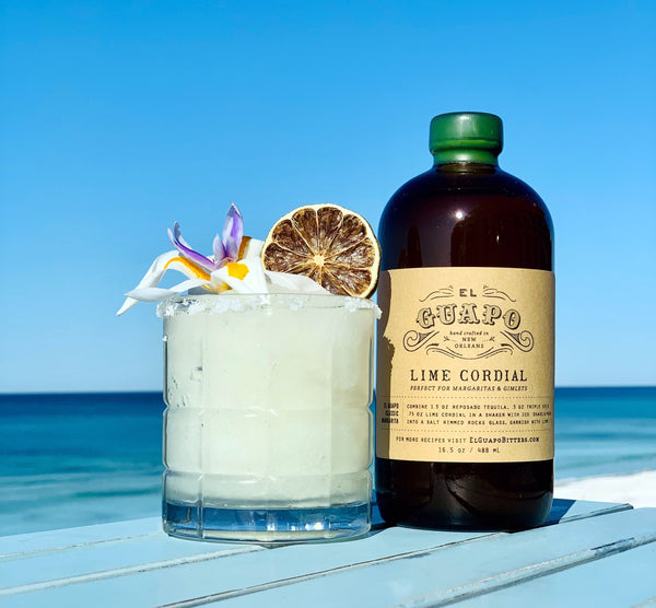 Frozen margarita cocktail on the beach next to El Guapo Lime Cordial