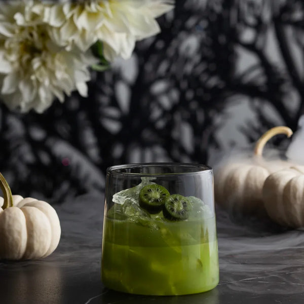 Half Life Margarita green chartreuse cocktail with a kiwi garnish and white pumpkins