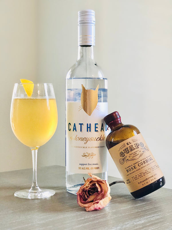 Honeysuckle Rose Collins cocktail with Cathead Vodka and El Guapo Rose Cordial bottles