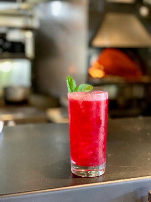 Ramblin' Rose verjus blanc cocktail in a highball glass garnished with fresh mint