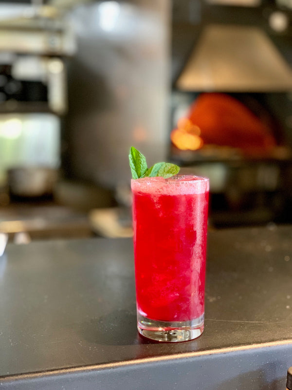 Ramblin' Rose verjus blanc cocktail in a highball glass garnished with fresh mint