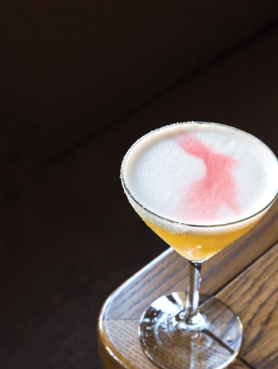 Andromeda New Orleans cocktail with foam top and red bitters design