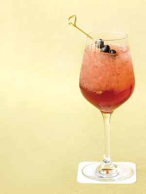 Blueberry Hill floral cocktail with crushed ice garnished with blueberries