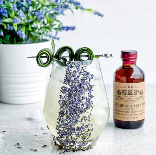 Cucumber and Lavender Cooler mocktail with a bottle of El Guapo Cucumber Lavender Bitters