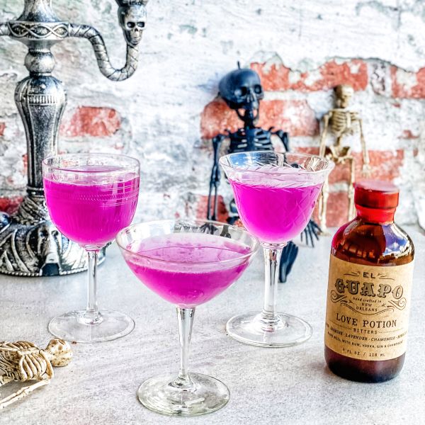 Purple Love Potion Gimlet cocktails next to El Guapo Love Potion Bitters