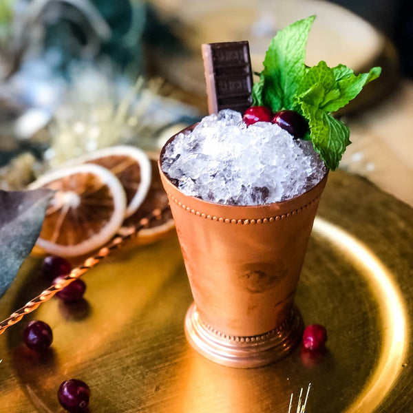Mint Chocolate Julep cocktail with crushed ice, fresh mint, and a piece of chocolate
