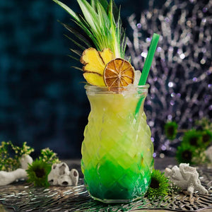 Pineapple Under the Sea tiki drink layered with blue curacao in a pineapple glass