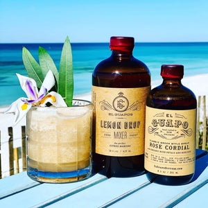 Rose lemonade slushee by the beach with El Guapo Lemon Drop Mixer and Rose Cordial