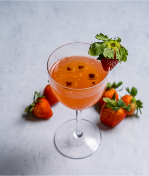 Strawberry Basil Balsamic Gin Cocktail in a coupe glass with a fresh strawberry garnish