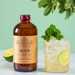 Fresh Mojito cocktail with lime and mint next to a bottle of El Guapo Mojito Mixer