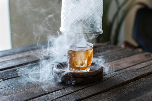 Smoked Chocolate Pecan Old Fashioned cocktail engulfed in swirling smoke