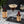 Espresso Martini with espresso bean garnish, El Guapo sweet potato syrup bottle, and chicory pecan bitters bottle on a marble surface decorated with espresso beans