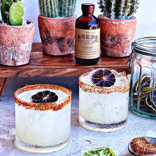 Spicy margaritas with seasoned rims made using El Guapo Fuego Bitters.