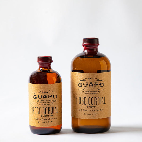 Small and large bottles of El Guapo Rose Cordial compared side by side on a white background