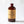 Glass full size bottle of El Guapo Salted Paloma Mixer on a white background