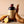 Bottle of Guapo Sweet Potato Syrup with sweet potatoes and cinnamon sticks on a beige background