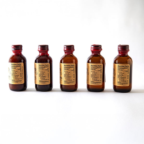 Side Angle of Five El Guapo Single Serving Mixer Bottles on a white background