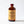 Small glass bottle of Creole Orgeat syrup with a brown label on a white background