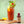 Bloody Mary cocktail with garnishes and a single serving bottle of El Guapo Bloody Mary Mixer on a wooden board.