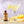 Sugar Rimmed Lemon Drop Martini with a bottle of Single Serving Guapo Lemon Drop Mixer on a wooden surface.