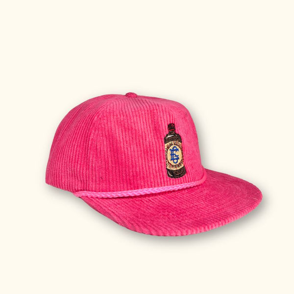 El Guapo hot pink corduroy baseball cap with bottle patch.