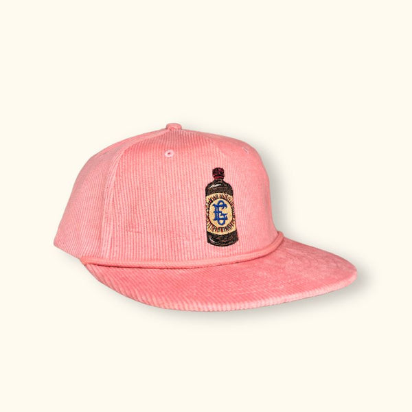 El Guapo light pink corduroy baseball cap with bottle patch.